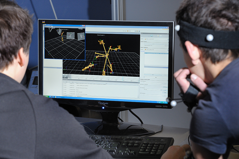 Forschung/Technik/Sport/Team wertet Daten an Bildschirm aus