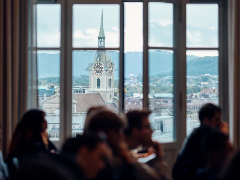 Students at the University of Bern in a lecture hall overlooking Bern
