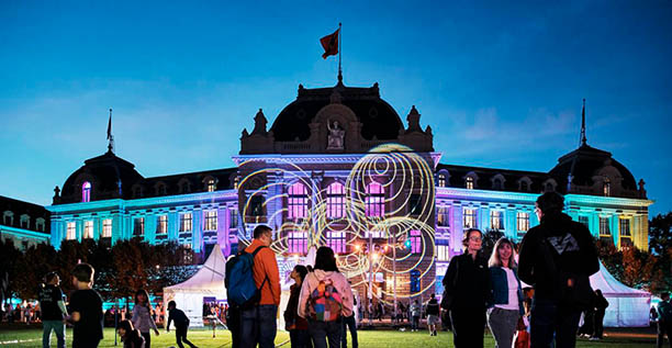 Beleuchtetes Hauptgebäude der Universität Bern